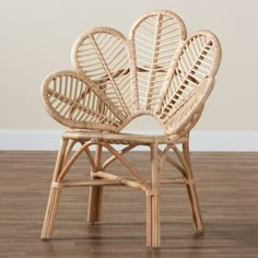 a chair made out of wicker with four large leaves on the back and sides