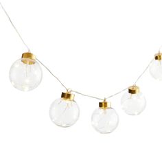 five clear glass globe lights hanging from a string on a white background with gold trim