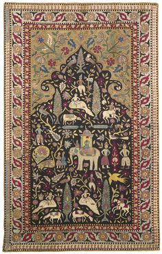 an intricately decorated rug with animals and flowers on black, red, yellow and green colors