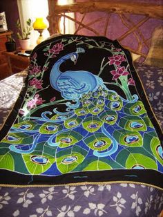 a peacock quilt on a bed in a bedroom