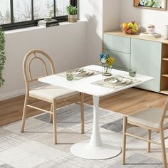 a white table and two chairs in a room