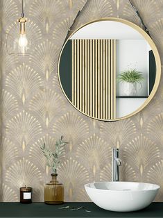 a bathroom sink with a mirror above it and a vase on the counter next to it