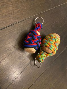 a knoted keychain is sitting on the floor next to a stuffed animal