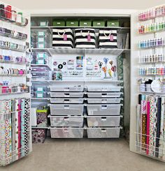 an organized closet with lots of craft supplies and storage bins on the shelves in front of it