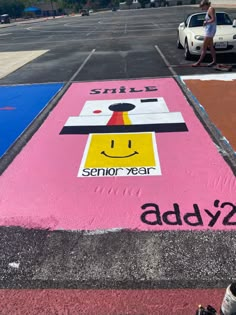 a painted parking lot with a smiley face on it and the words smile, senior year added