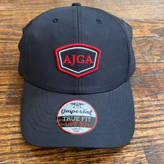 Imperial Branded Golf Hat. Velcro Closure. 100% Polyester. Black Adjustable Hats For Golf, Black Cap For Golf, Black Six-panel Golf Hat, Adjustable Black Hat For Golf, Adjustable Black Golf Hat, Black Golf Cap, Black Curved Brim Baseball Cap For Golf, Black Golf Hat With Curved Brim, Black Snapback Golf Hat