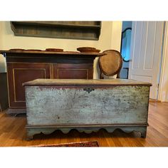 an old chest sitting on top of a hard wood floor