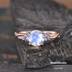 a ring with an oval blue topazte surrounded by pink tourmaline and white diamonds