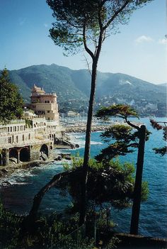 an old building sitting next to the ocean