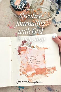 an open book with the words creative journal written on it and some paint splatters