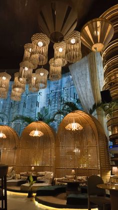 the restaurant is decorated in bamboo and features round chandeliers hanging from the ceiling