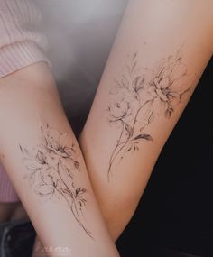 two women with matching tattoos on their arms