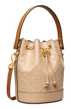 Embossed patent leather provides textural intrigue on this scaled-down bucket bag featuring a drawstring closure cinched with a logo-embellished toggle. Drawstring closure Top carry handle; removable, adjustable crossbody strap Flat base for stability Lined Leather Imported T Monogram, Leather Bucket Bag, Leather Bucket, Crossbody Strap, Emboss, Bucket Bag, Patent Leather, Tory Burch, Nordstrom