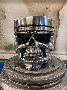 a metal skull head sitting on top of a machine