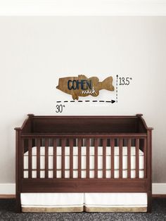 a baby crib with a wooden sign that says coffee break on the wall next to it