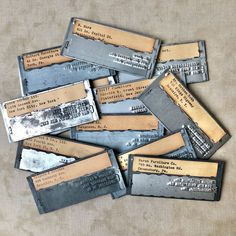 many old metal tags are stacked on top of each other