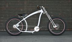 a white bicycle parked in front of a garage door