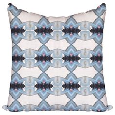 a blue and white pillow with an abstract design on the front, in shades of grey