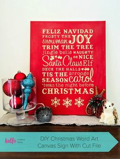 a red christmas sign sitting on top of a wooden table next to other holiday decorations