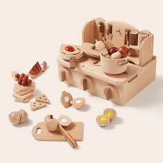 a wooden toy kitchen set with various items