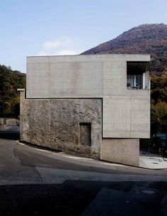 the building is made out of concrete and has an open window on it's side