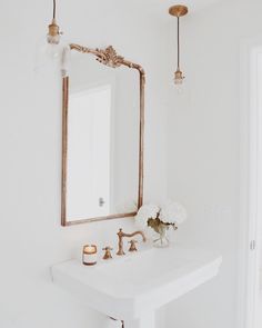 a bathroom with a sink, mirror and lights