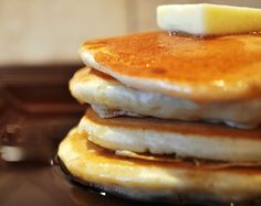 a stack of pancakes with butter and syrup on top