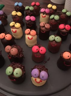 there are many different types of cakes on the trays that have faces and noses