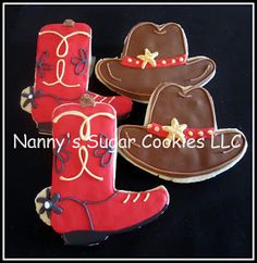 three decorated cookies in the shape of cowboy boots