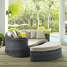 an outdoor living room with wicker furniture