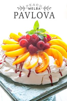 there is a cake with fruit on it and the words pavlova written in white