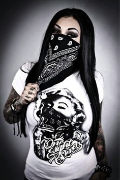 a woman with long black hair wearing a bandana