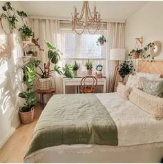 a bed room with a neatly made bed and lots of plants