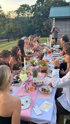 a group of people sitting around a table eating food