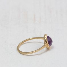 Purple Amethyst ring A dainty gold ring set at its center with a natural Amethyst gemstone. The stone is milgrain set with much attention to detail giving it an antiquated look. Handmade to perfection to bring out the purple beauty and clarity of this amethyst gemstone. Perfect for stacking with chevron rings. -Made to Order, perfectly finished, Fast shipping fully insured and trackable online. -Gemstone info: 7 mm Amethyst, Cabochon cut. -Ring width: 1.4 mm -Arrives gift ready with a certificat Elegant Amethyst Birthstone Crystal Ring, Minimalist Gold Amethyst Ring, Faceted Amethyst Ring In Yellow Gold Fine Jewelry, Fine Jewelry Amethyst Gold Ring, Fine Jewelry Gold Amethyst Ring, Fine Jewelry Gold Ring With Amethyst, Gold Amethyst Open Ring Fine Jewelry, Faceted Crystal Promise Ring In Fine Jewelry Style, Gold Faceted Amethyst Ring