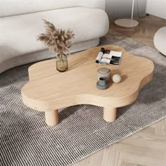 a wooden table sitting on top of a carpeted floor next to a white couch