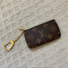 a purse with a keychain hanging from it's side on a carpet