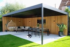 an outdoor living area with furniture and a dog laying on the ground in front of it