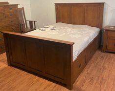 a bedroom with wooden furniture and hard wood flooring