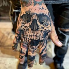 a hand with a skull tattoo on it