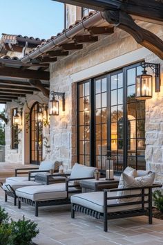 an outdoor living area with couches and lamps