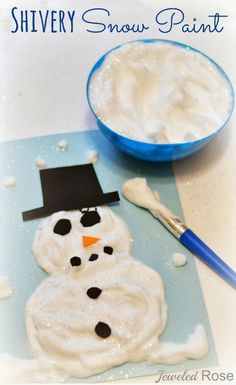 a snowman made out of foam sitting next to a bowl of white frosting