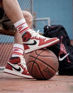 a man sitting on top of a basketball next to a bag