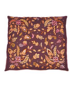 a purple pillow with colorful leaves on it