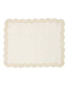 a white place mat with scalloped edges