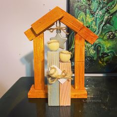 a nativity scene made out of wood and painted with acrylic paint on it