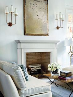 a living room filled with furniture and a fire place in front of a painting on the wall