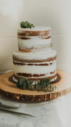 a three tiered cake sitting on top of a wooden plate