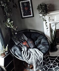 a living room filled with furniture next to a fire place and potted plants on top of a table