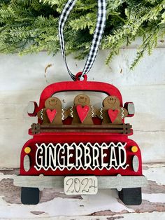 a christmas ornament with gingerbread cookies in the back of a red truck